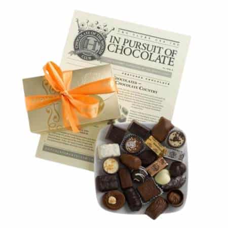 The Gourmet Chocolate Of The Month Club chocolate subscription box with flyer and gift box.