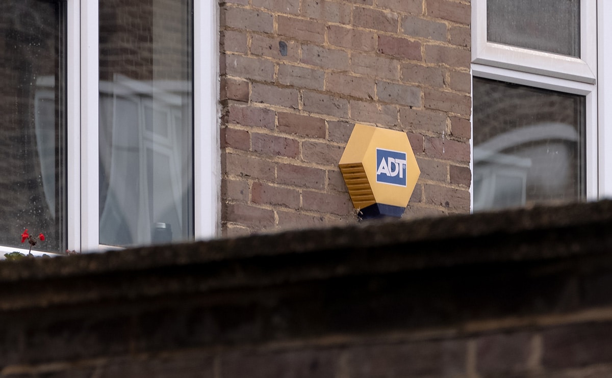 ADT home security sign on brick exterior