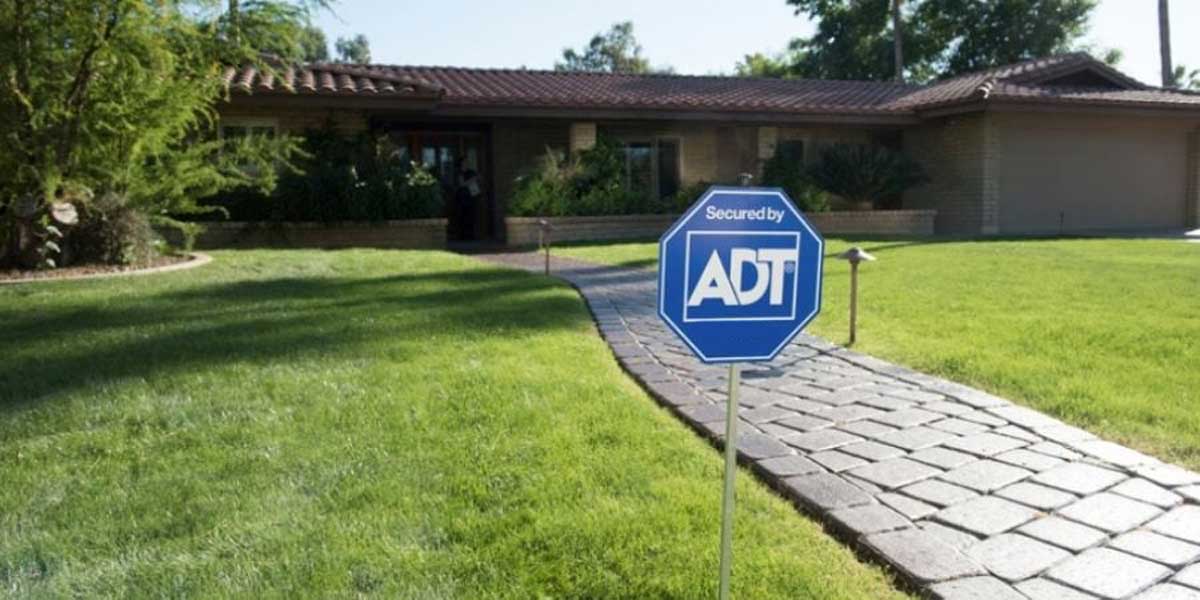 ADT yard sign in front yard of home