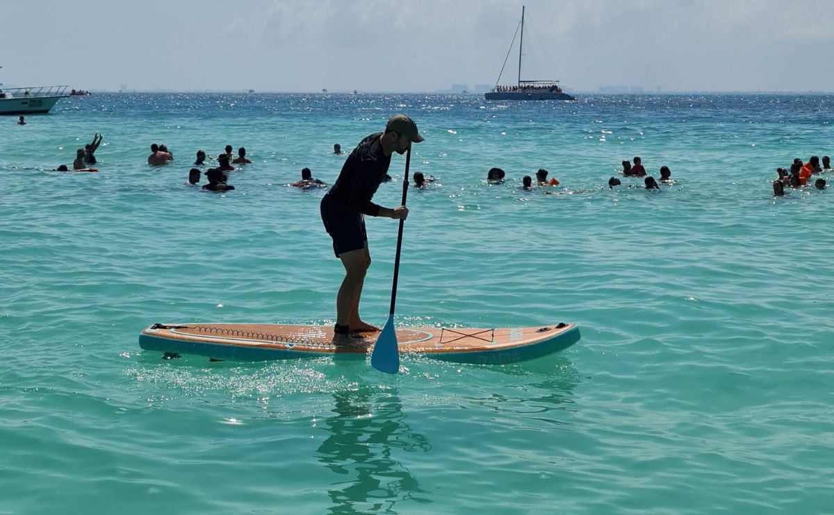 Alex on an inflatable paddle board in the ocean off coast of Mexico.