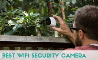 Man setting up an Arlo security camera outside (Caption: Best WiFi Security Camera)