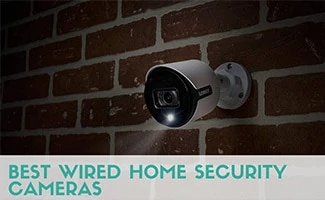 An outdoor security camera installed in a brick wall on a dark night. Caption: Best Wired Home Security Cameras