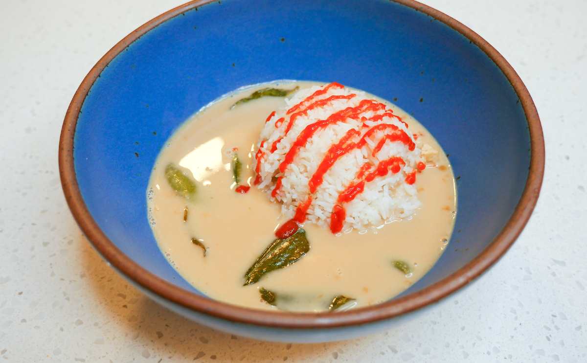 A bowl of Panang curry on a counter.