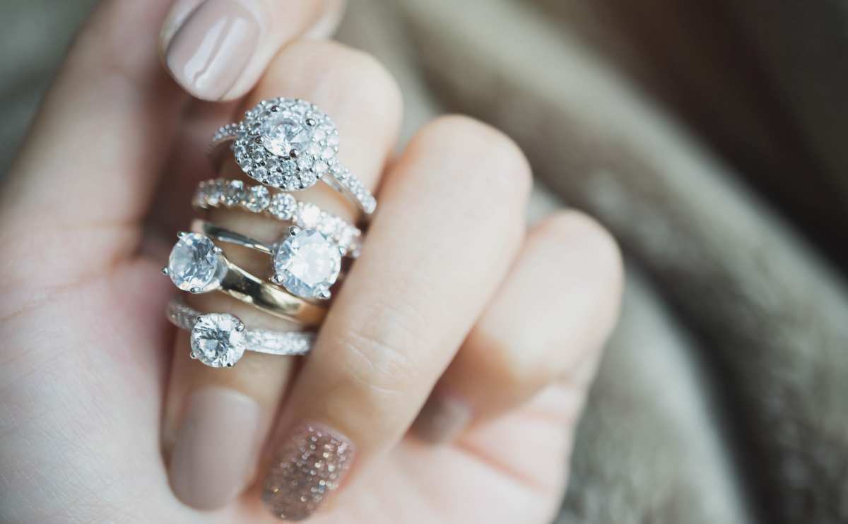 Close up of diamond rings on a woman's finger.