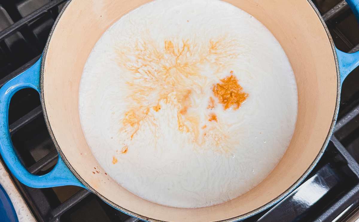 Coconut milk simmering in a pot.