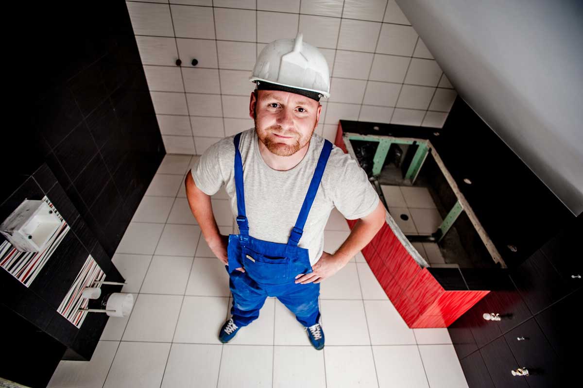 Repair technician repairing a bathroom