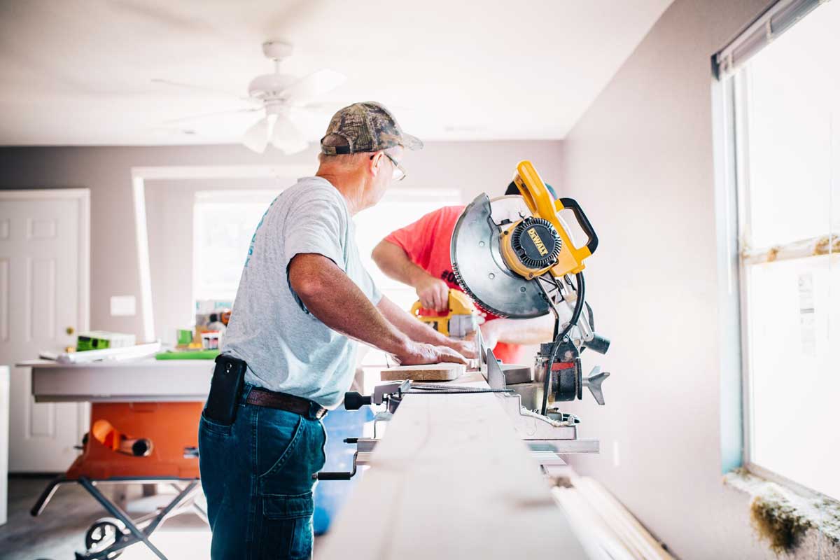 Contractors repairing a kitchen counter