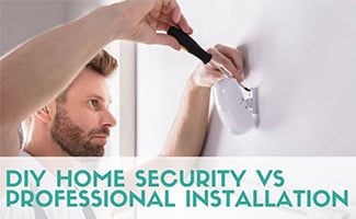 Man installing home security camera (caption: DIY Home Security vs Professional Installation)