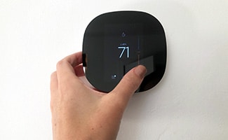 ecobee lite 3 with hand adjusting temperature