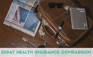 Suitcase with papers and book (Caption: Expat Health Insurance Comparison)