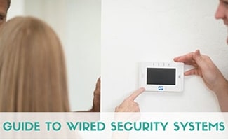 Lady with ADT keypad and installer (Caption: Guide to Wired Security Systems)