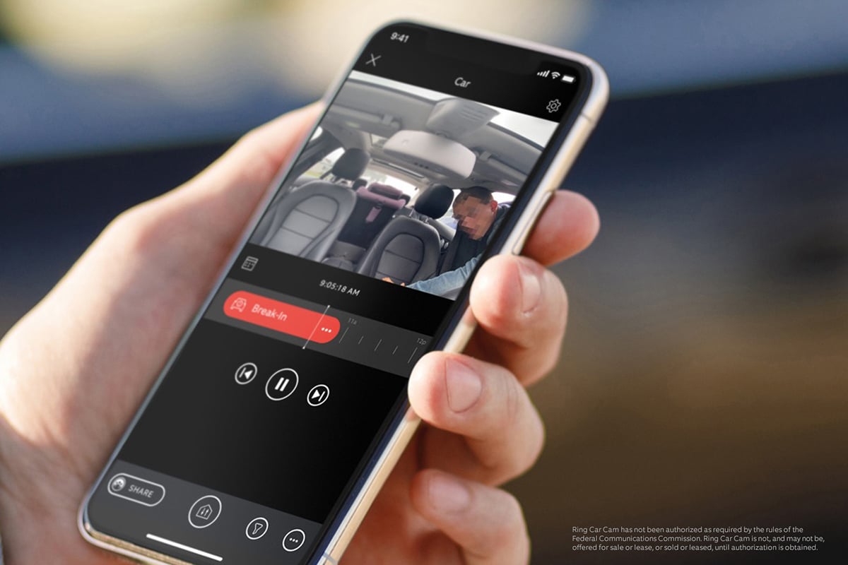 hand holding cellphone showing ring car cam footage