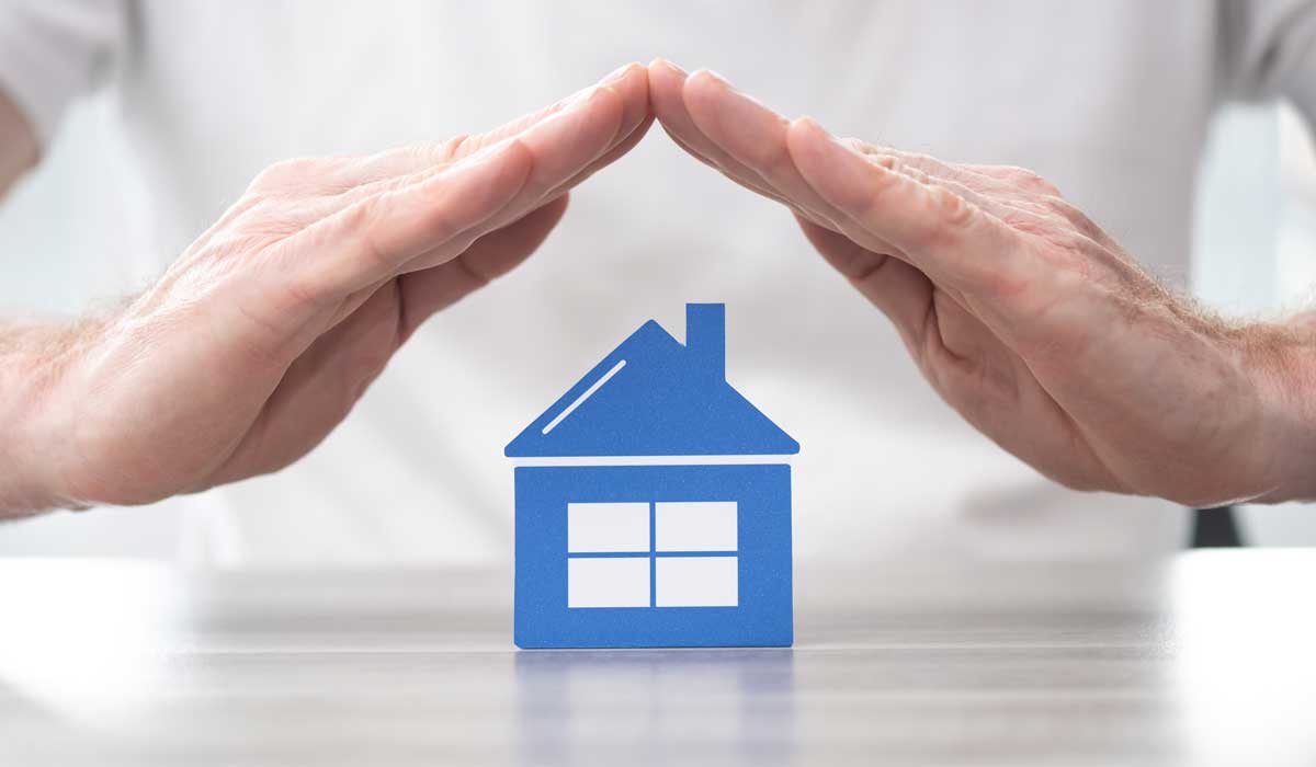 Hands forming roof over blue house icon