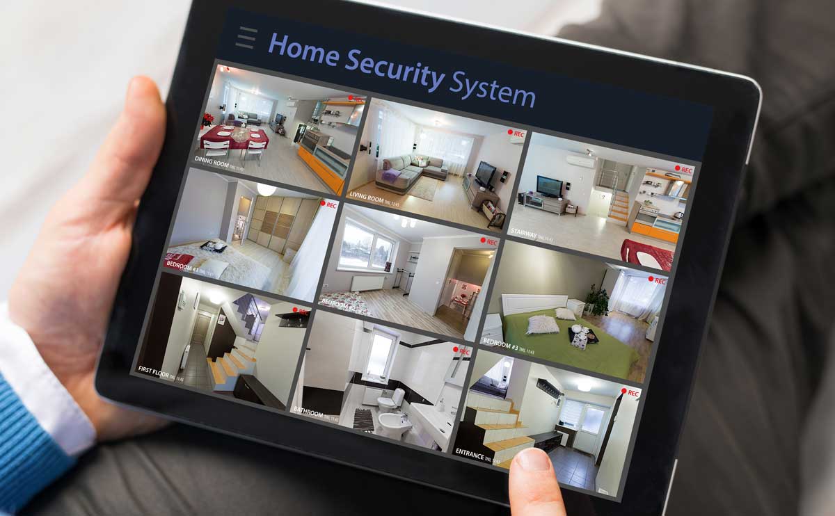 Home security tablet showing security feeds in persons lap