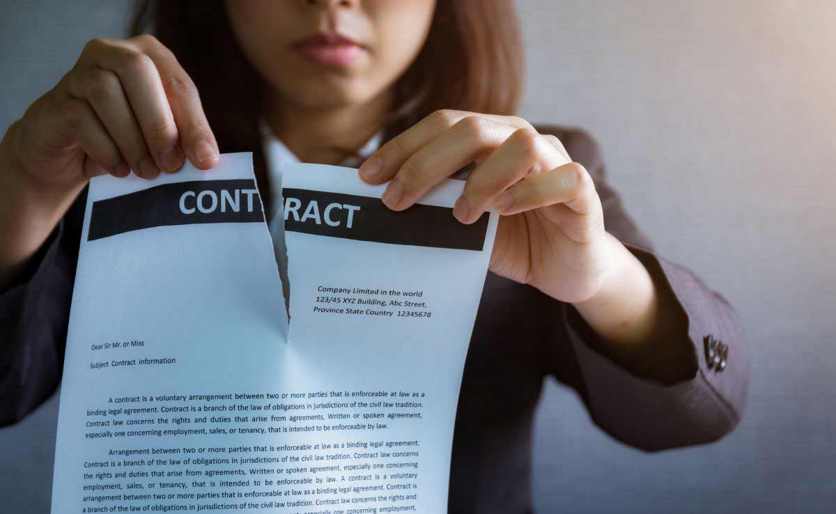 Lawyer woman tearing up a document, contract or agreement in office