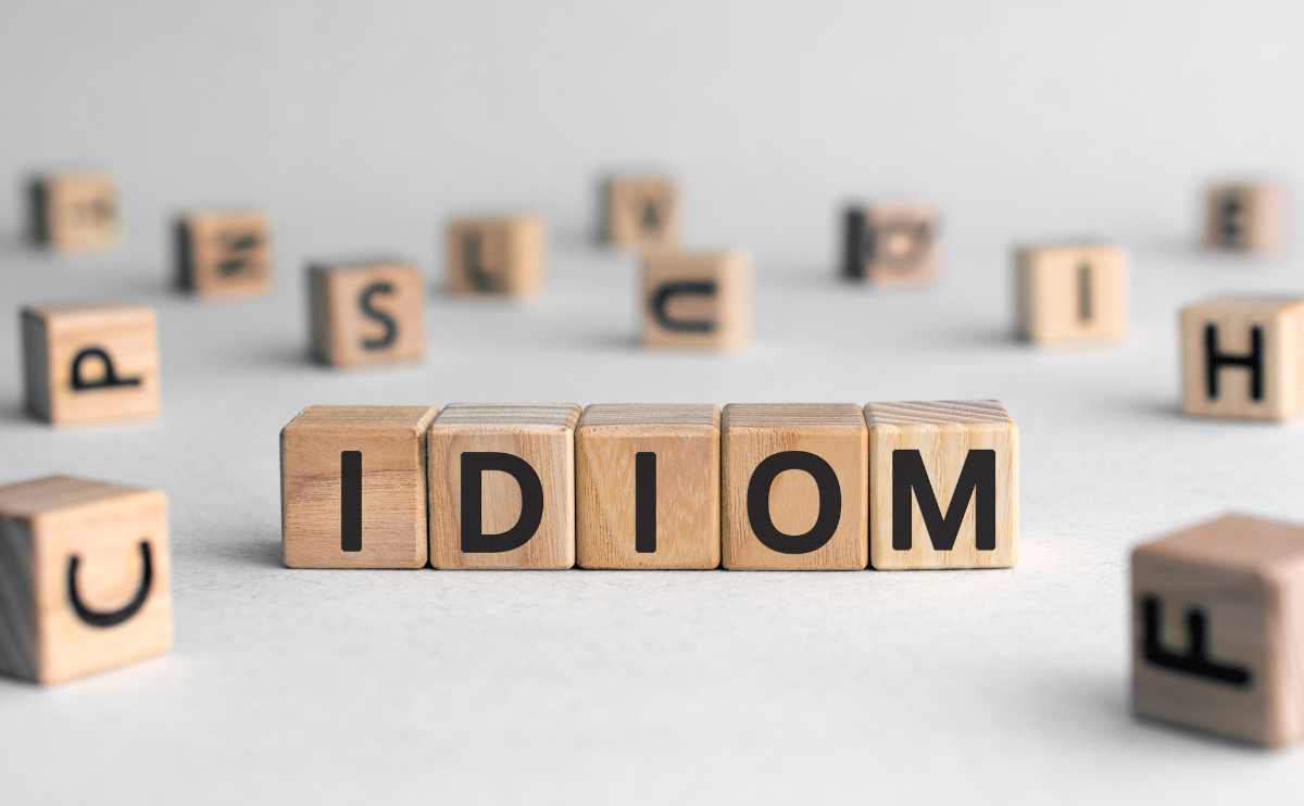 Idiom spelled out in blocks with random letters scattered around the background.