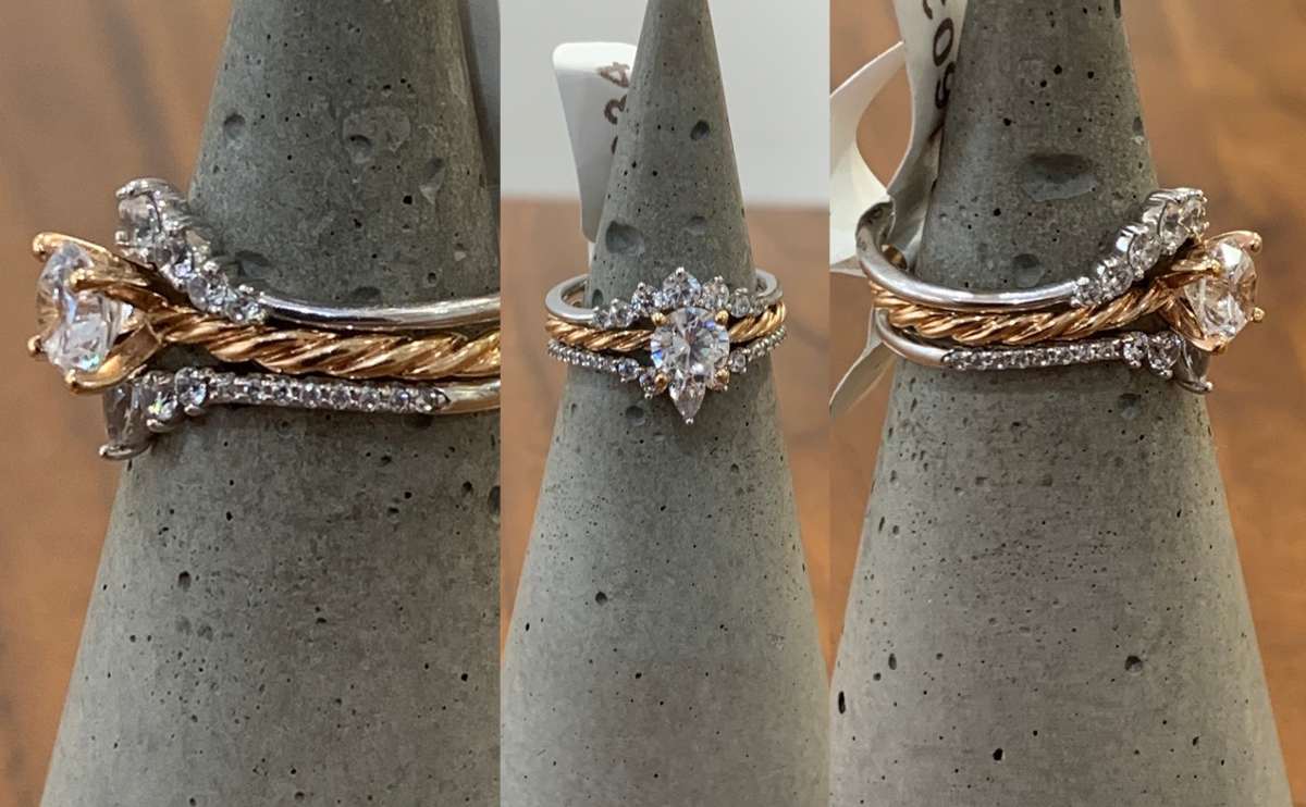 James Allen stacked engagement and wedding bands from 3 angles on a ring stand.
