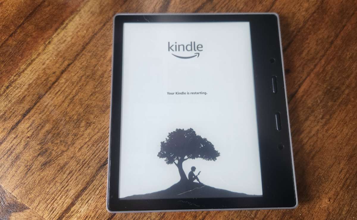 Kindle e-reader on a wooden table.