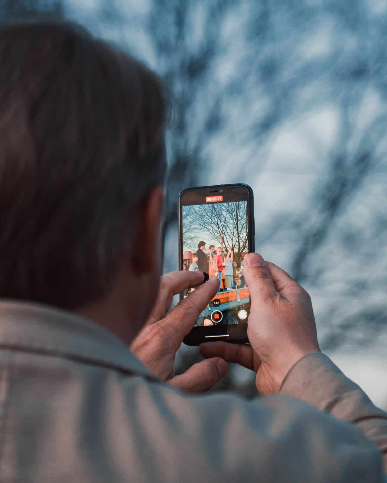 man filming on cellphone