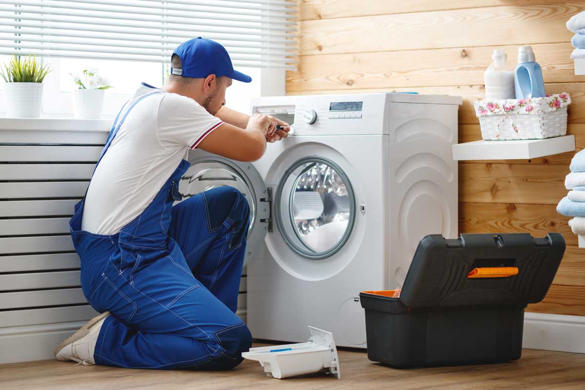 Man repairing washing machine