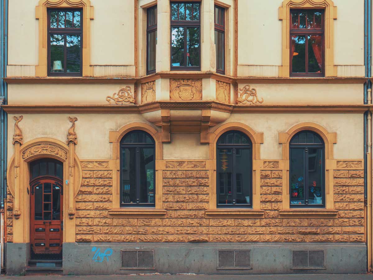 Old stone building with brick accent and red front door