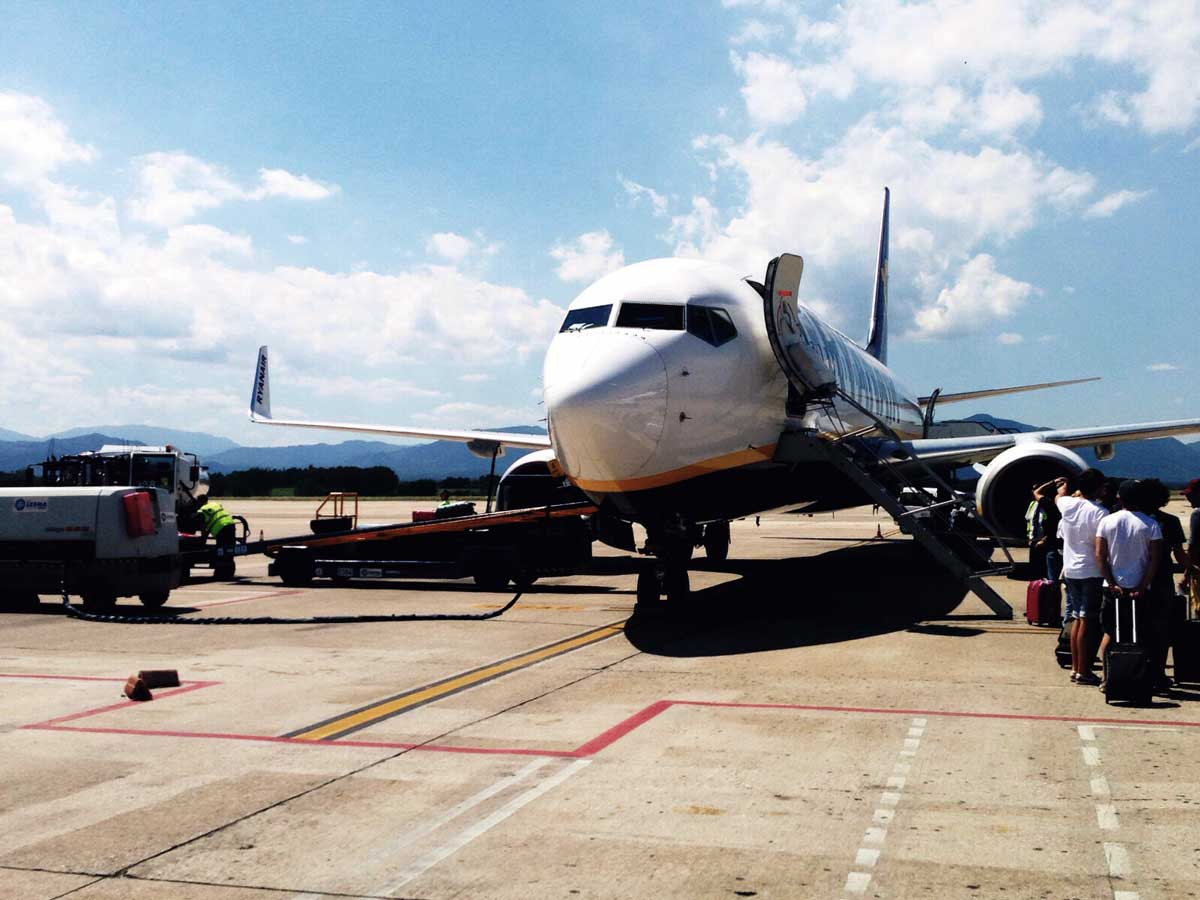 passengers boarding an airplane on tarmac jpg