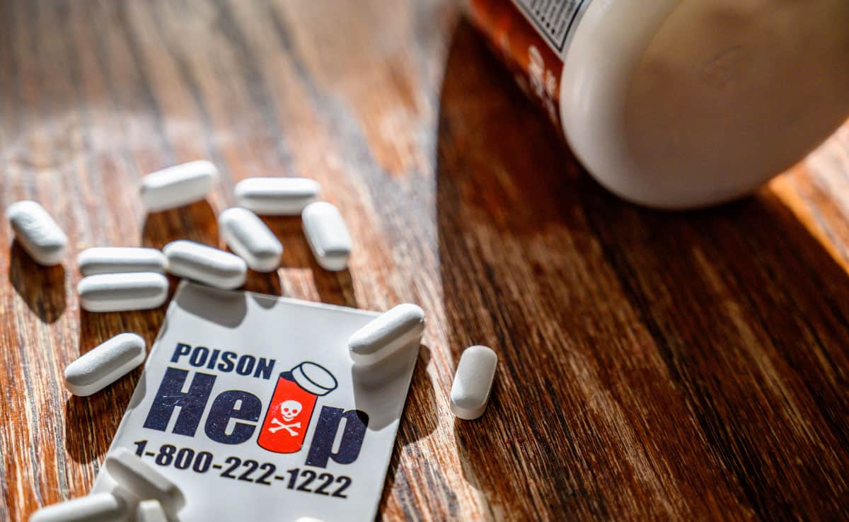 Poison control hotline number with assorted medical pills