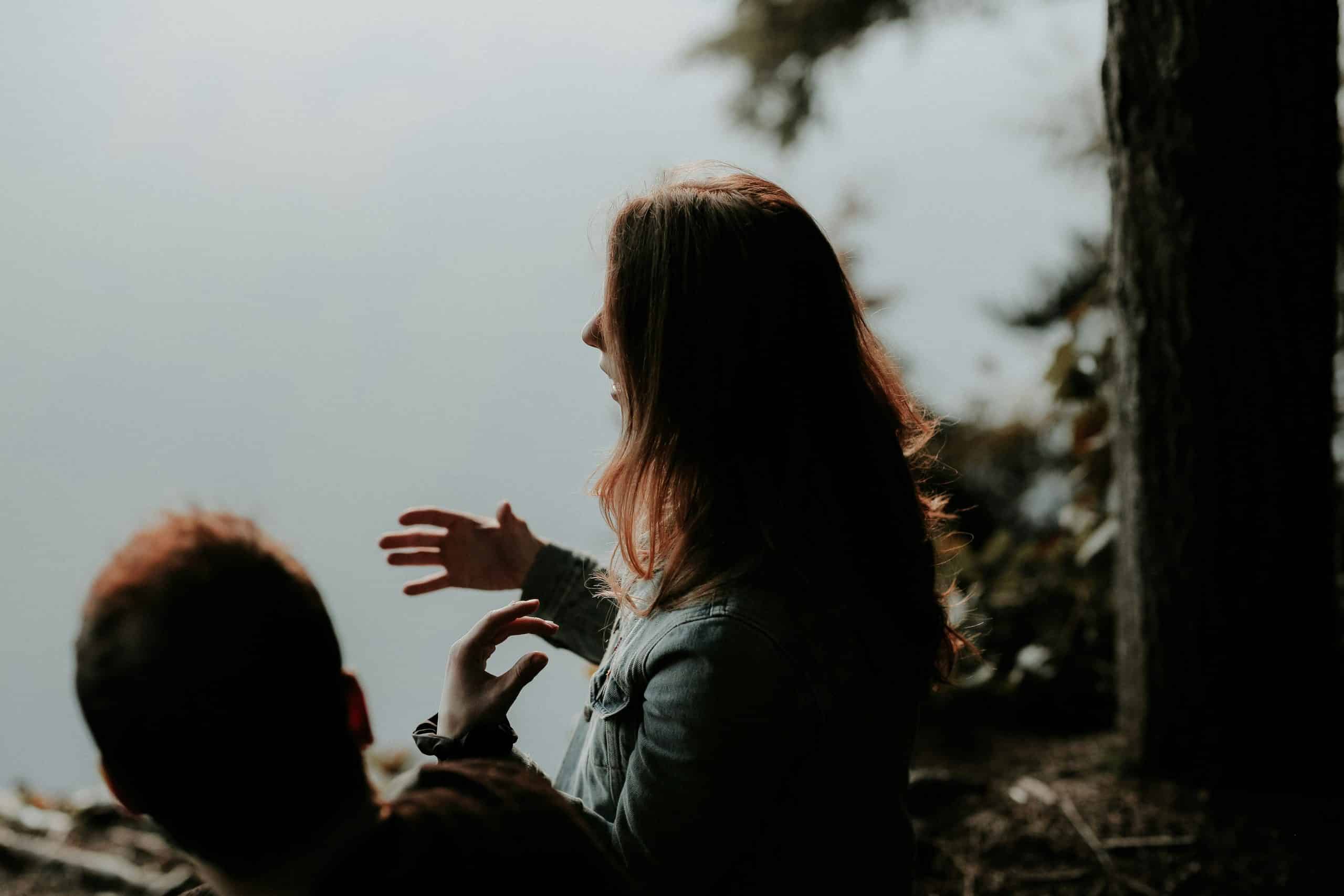 Two people talking outside