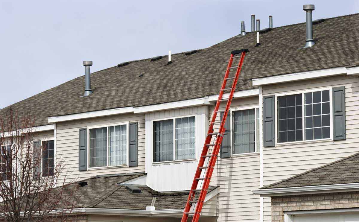 red ladder leaning on home