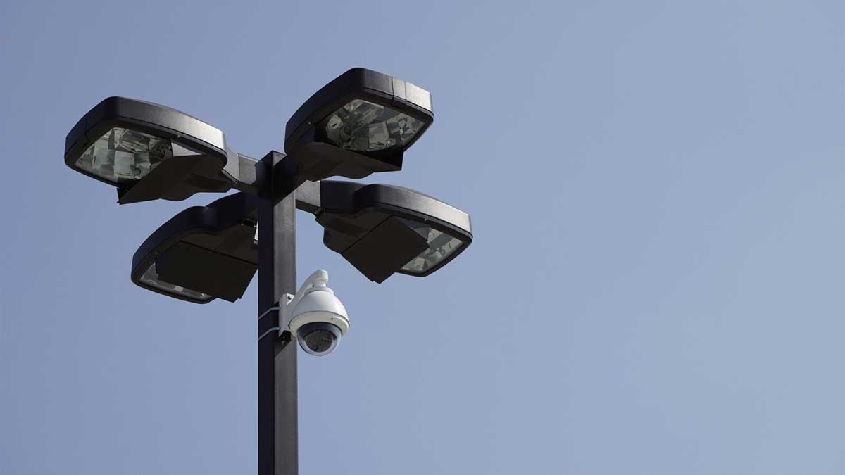 Security camera mounted on parking lot lights