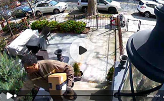 Postman delivering package on security camera