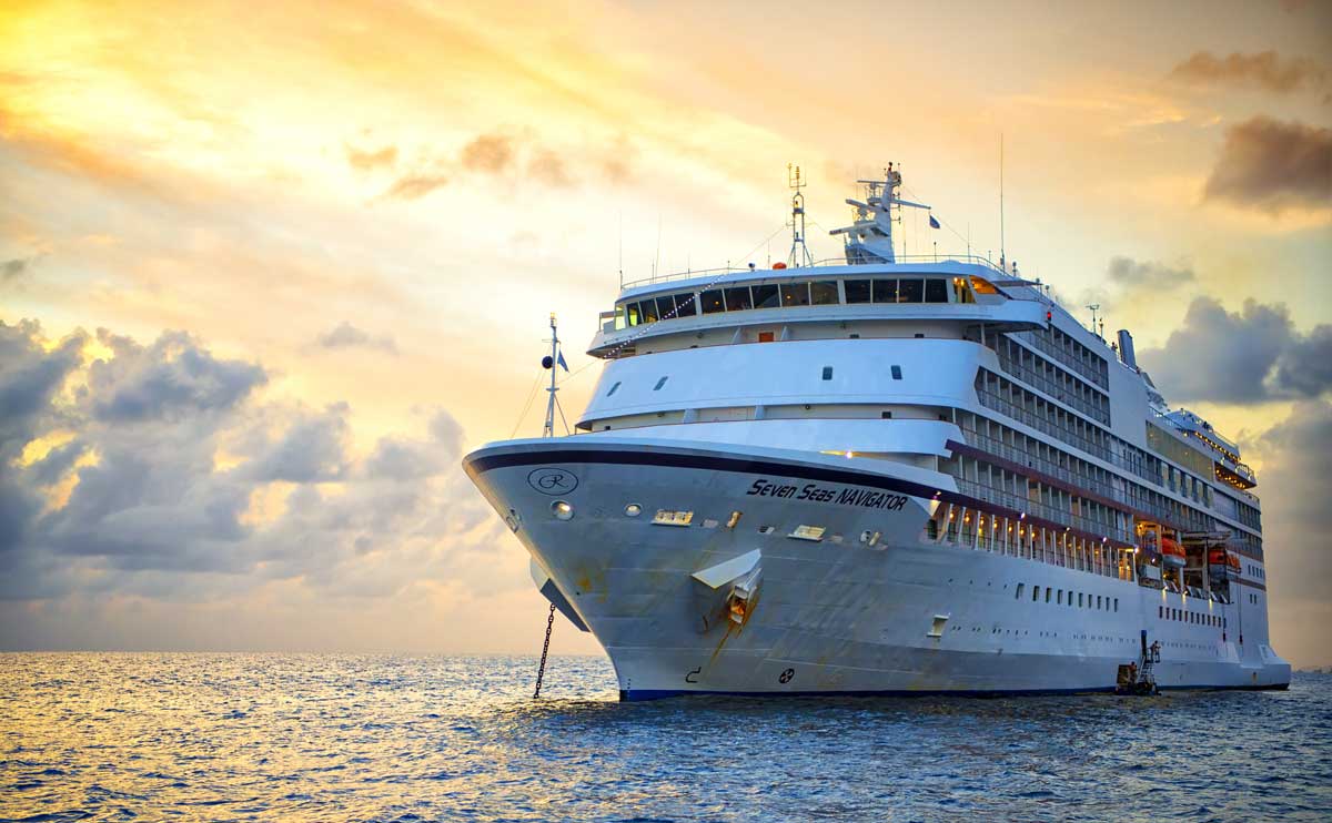 Beautiful marine view with one large cruise liner ship called Regent Navigator of Regent Seveneseas cruise line in port on sunset background.