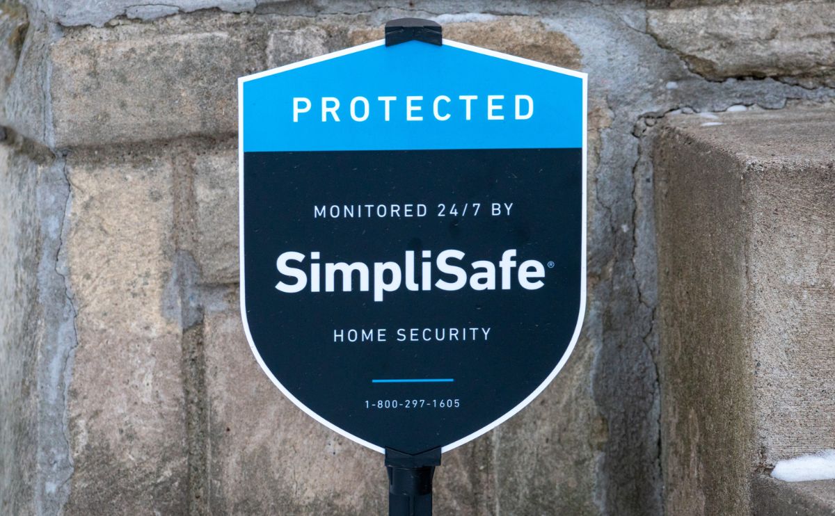 SimpliSafe sign in front of a house up close.