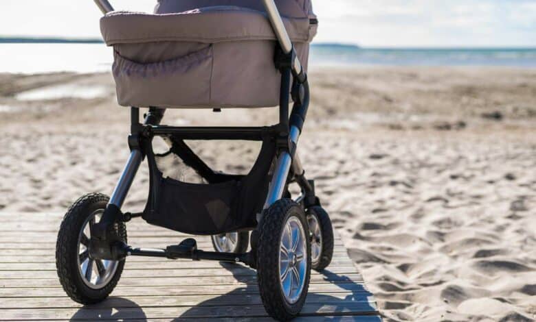 Stroller parked on the beach.