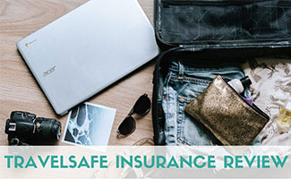 Computer next to suitcase (caption: TravelSafe Insurance Review)