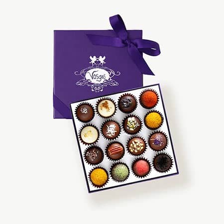 Vosges haut chocolate subscription box open showing 16 chocolates.