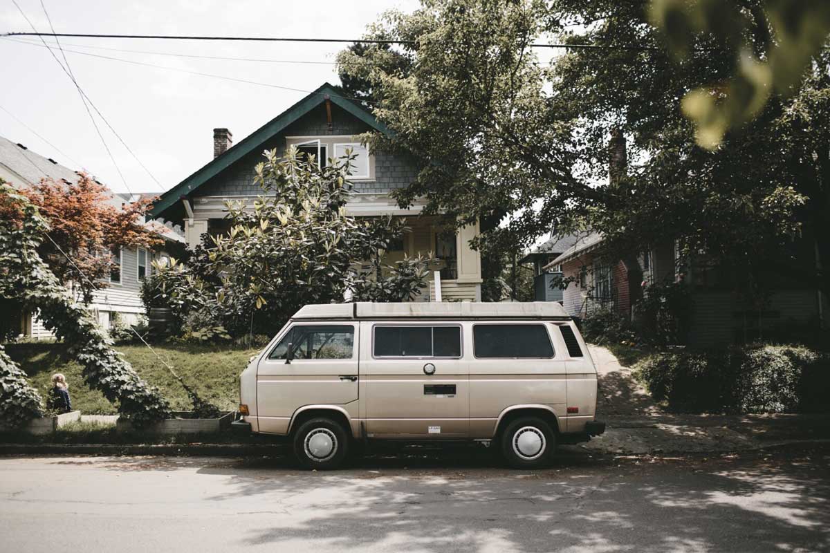 White utility van parked outside house