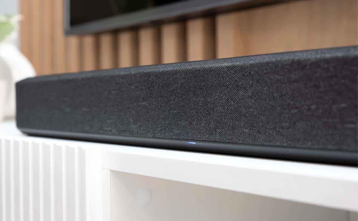 Wireless soundbar on a TV stand up close.