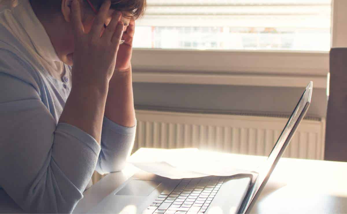 Woman struggling to read on a computer.