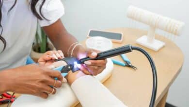 Woman welding jewelry on customer.