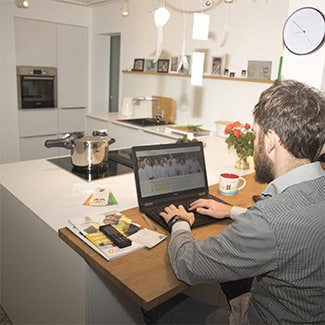 Man working from kitchen counter