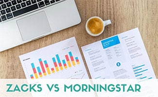 Investing papers on a desk next to computer (caption: Zacks vs Morningstar)